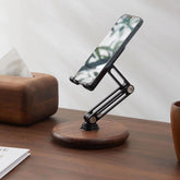 A smartphone displaying a nature background held by the Super Wooden Phone Stand on a wooden desk | Cyber Vintage